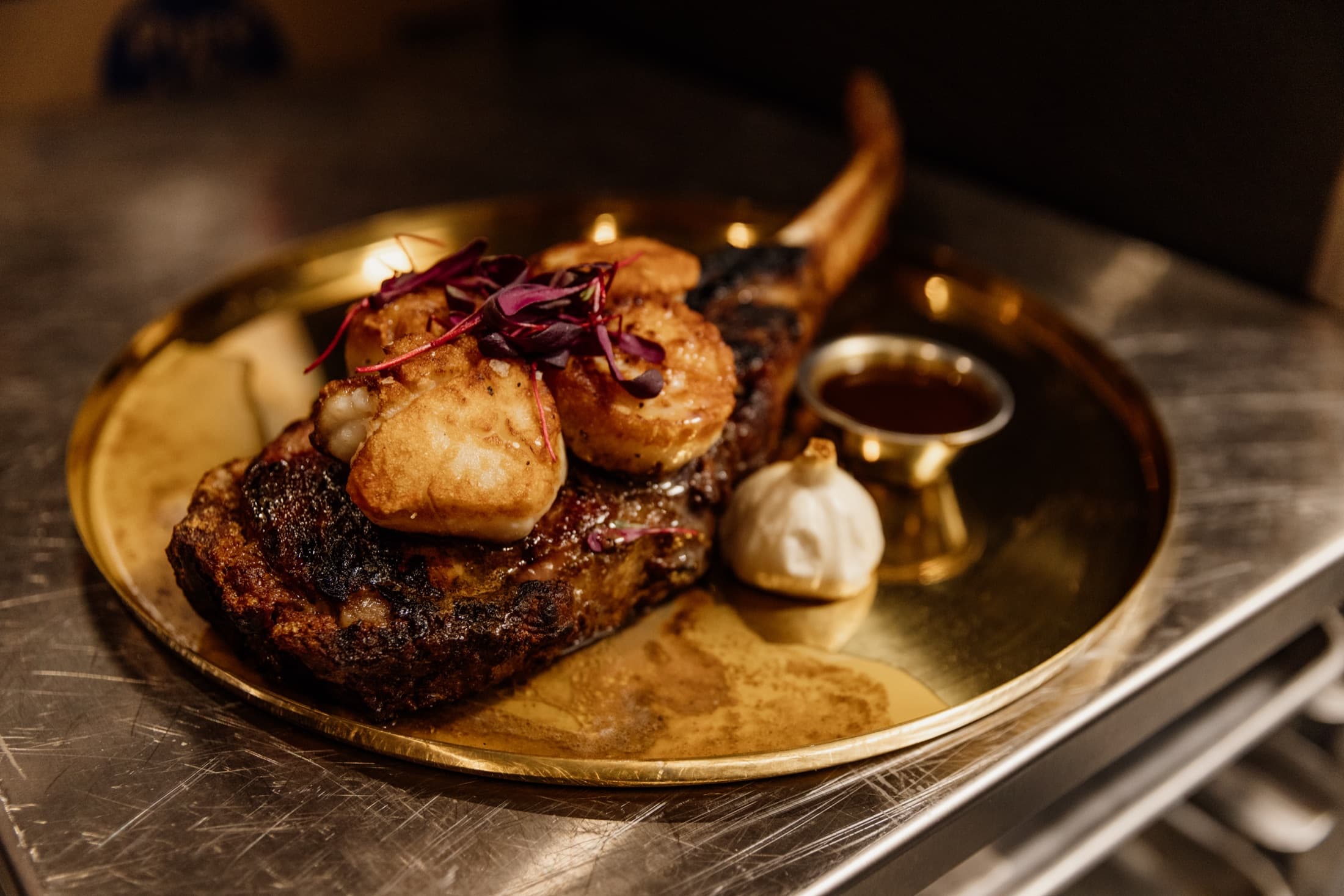 32oz USDA Prime tomahawk steak, dry-aged in house and finished with seared scallops