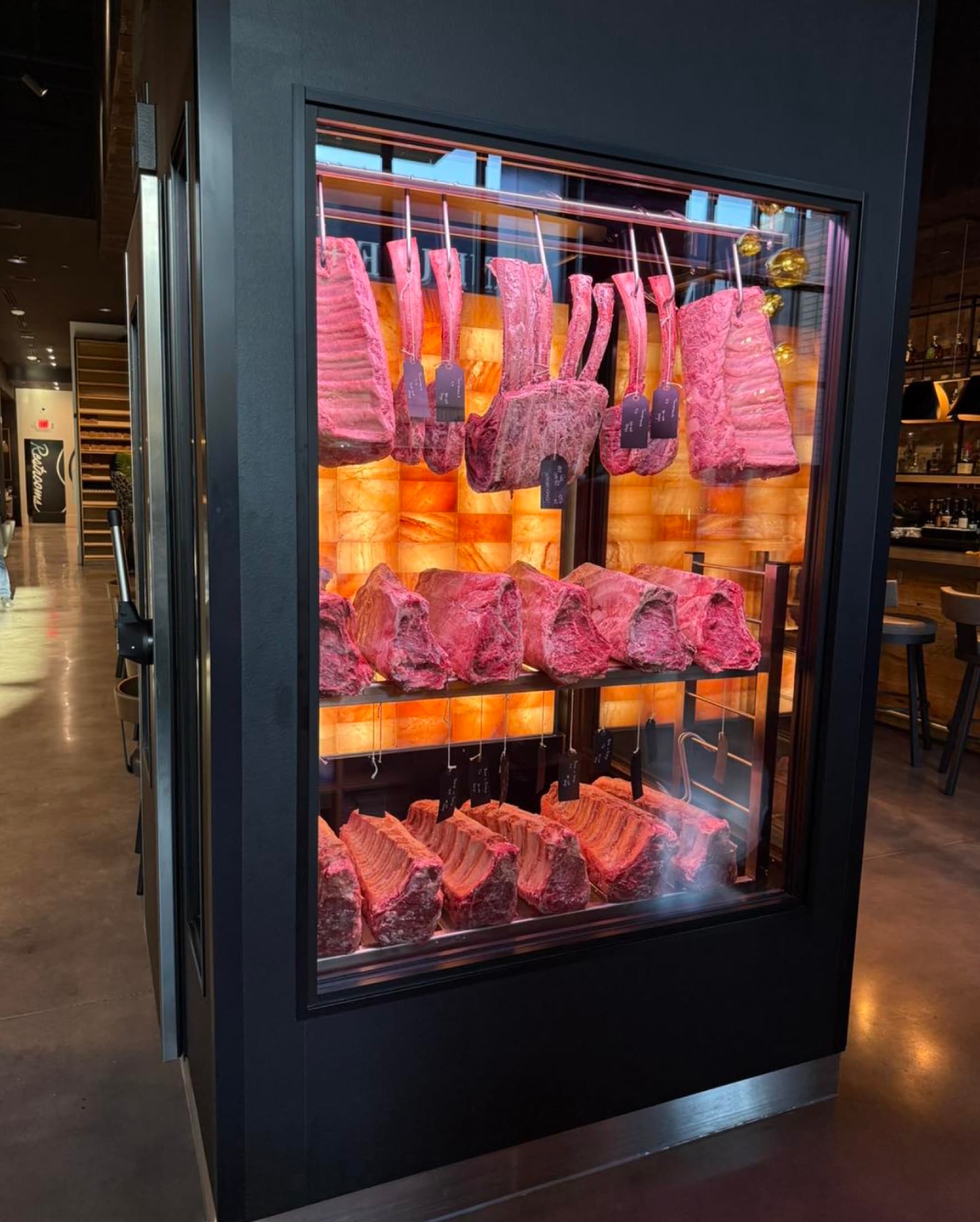 In-house dry-aging case displaying prime beef at CHR Steak
