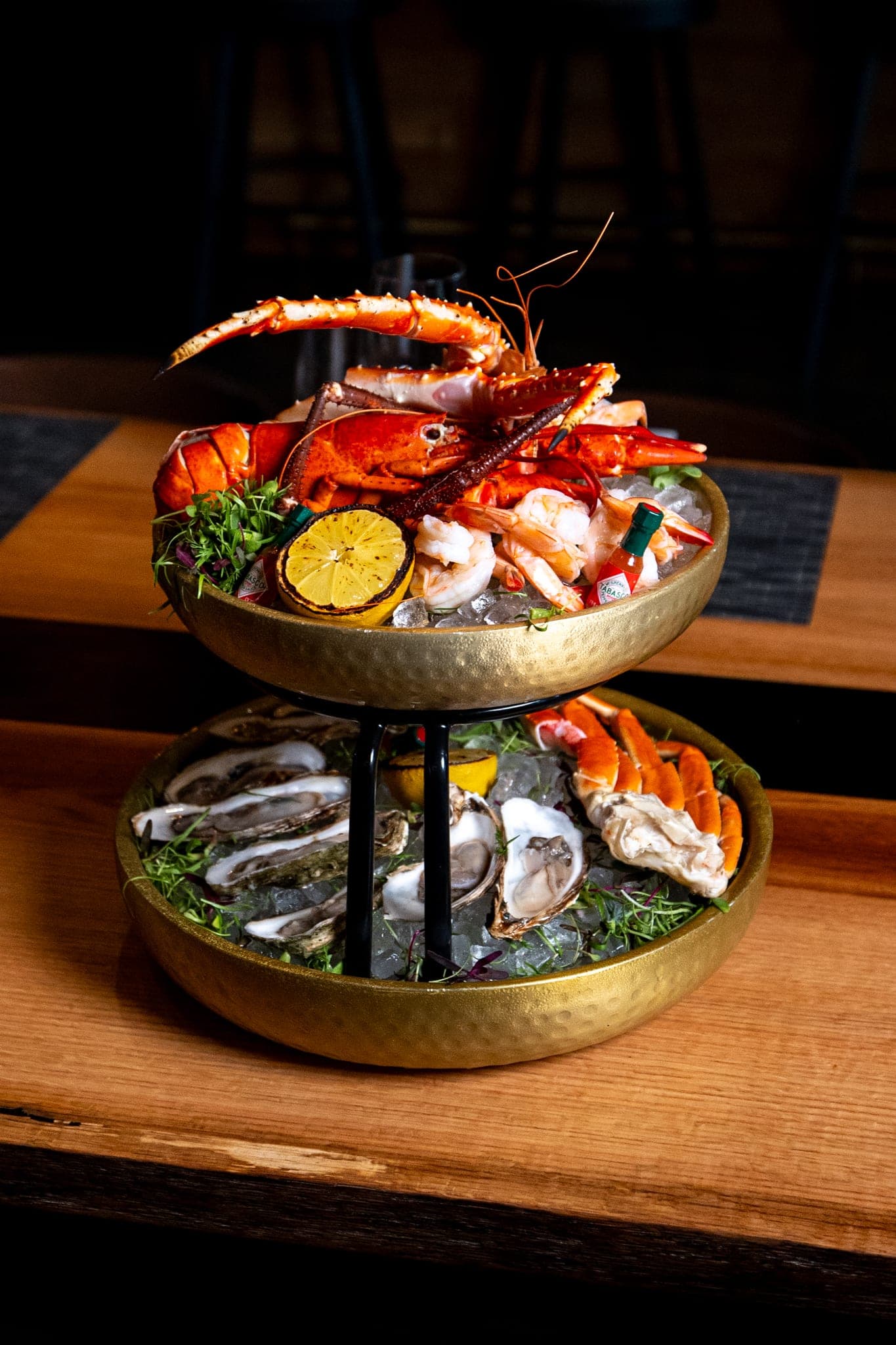 Raw bar sea tower with oysters, prawns, shrimp, stone crab, king crab, and Maine lobster